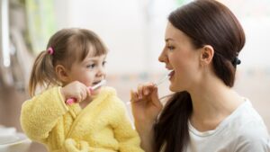 Pediatric Dentistry Faq Mother And Child Brushing Teeth